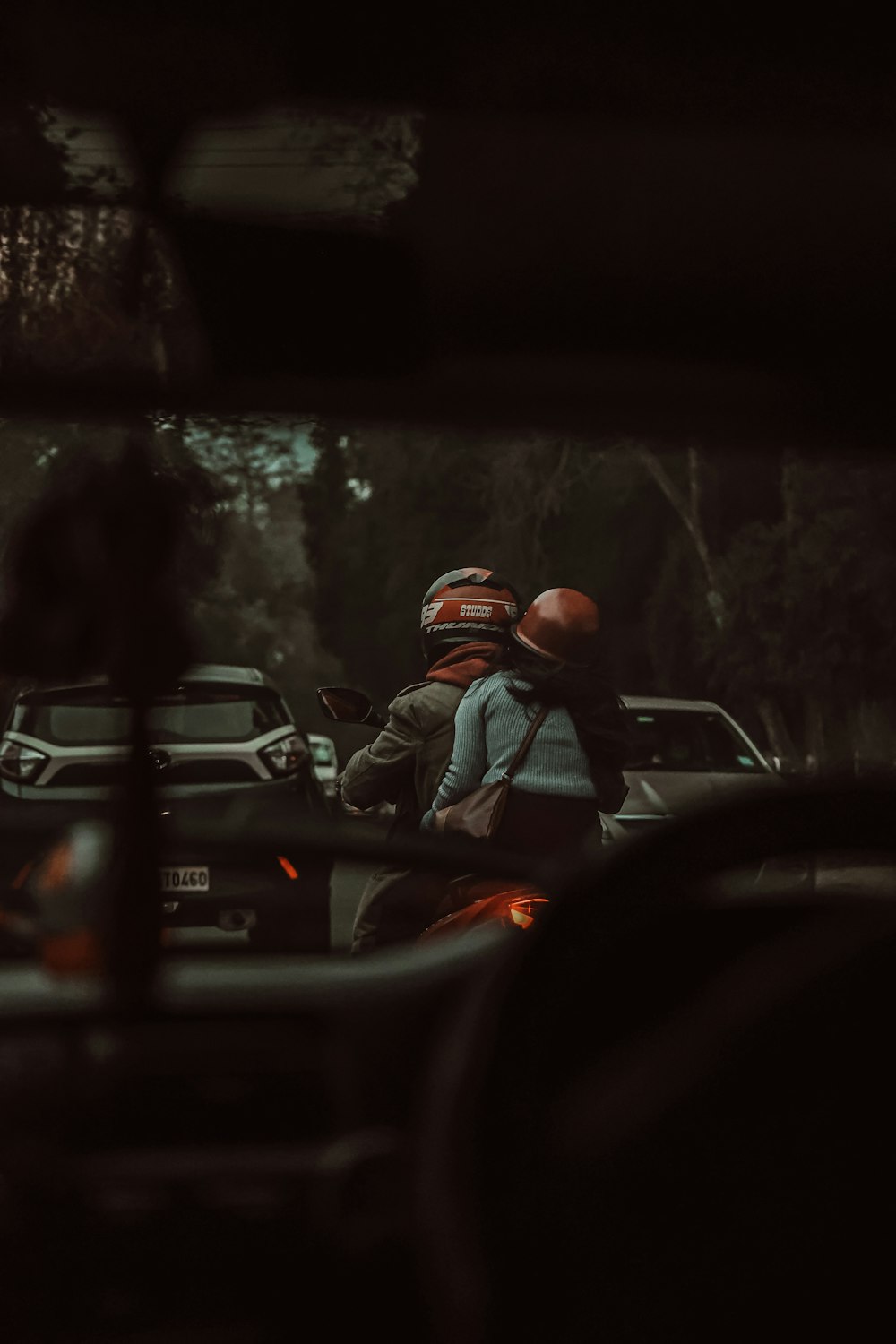 man in black jacket sitting on car seat