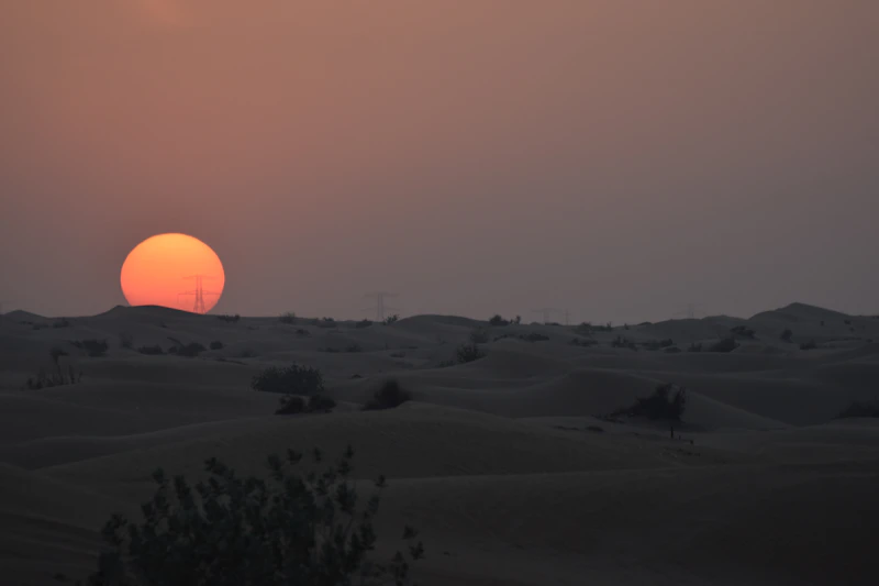 Sun setting over the Dubai desert dunes