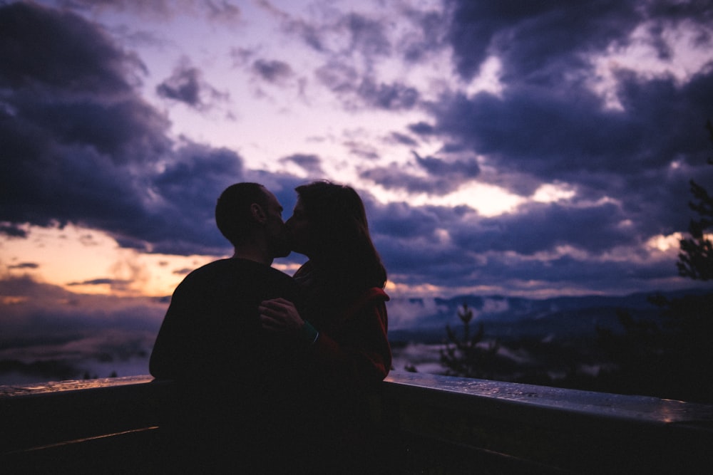 silhouette of man and woman kissing