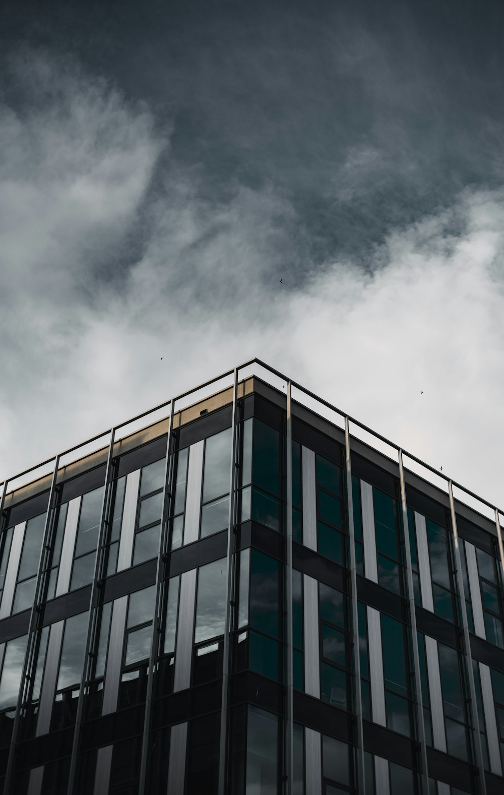 blue and white concrete building under cloudy sky during daytime