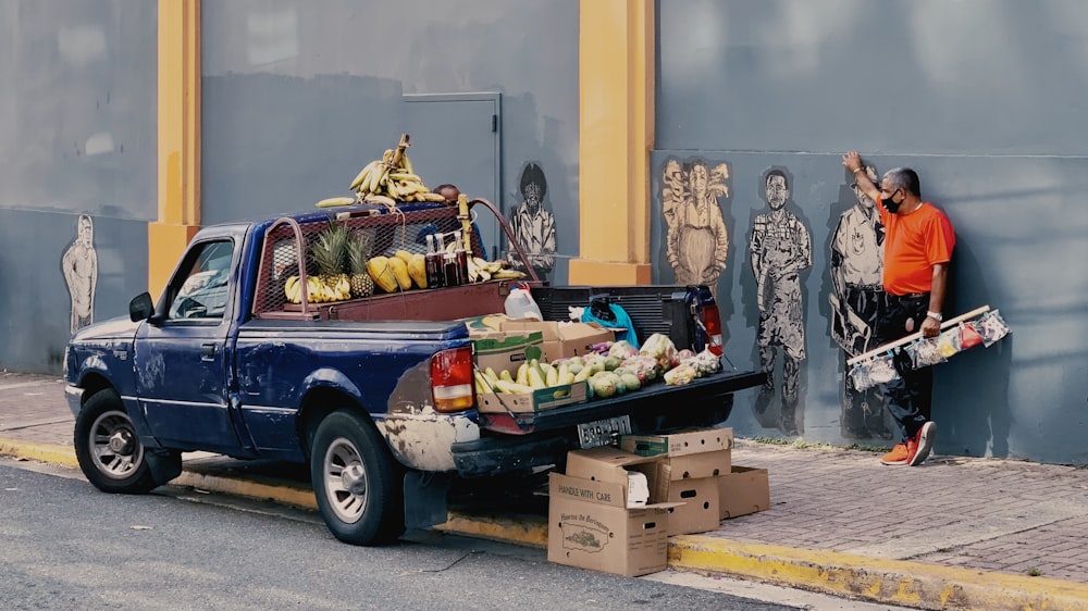 black and white single cab pickup truck with fruits and vegetables