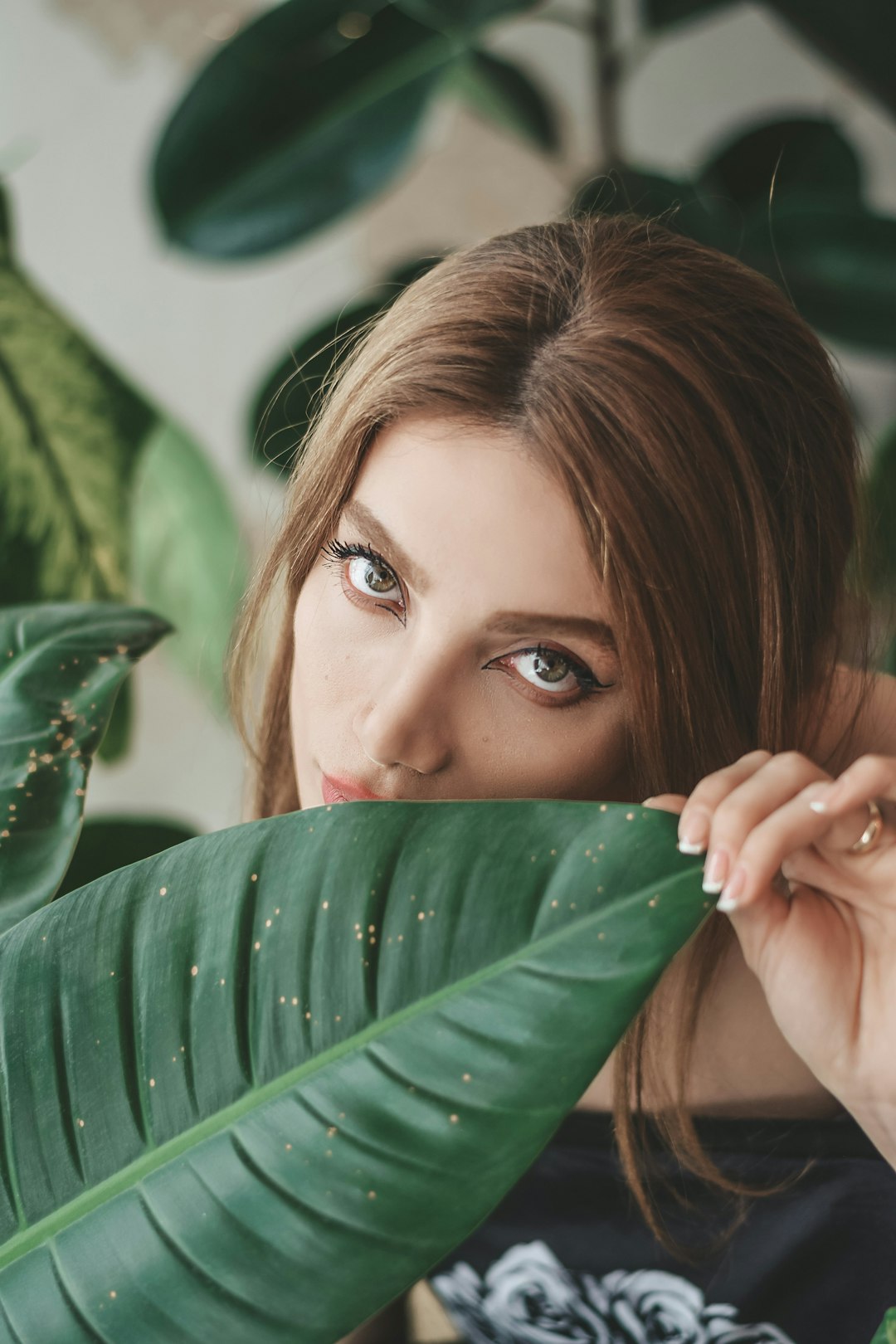 woman holding green leaf during daytime