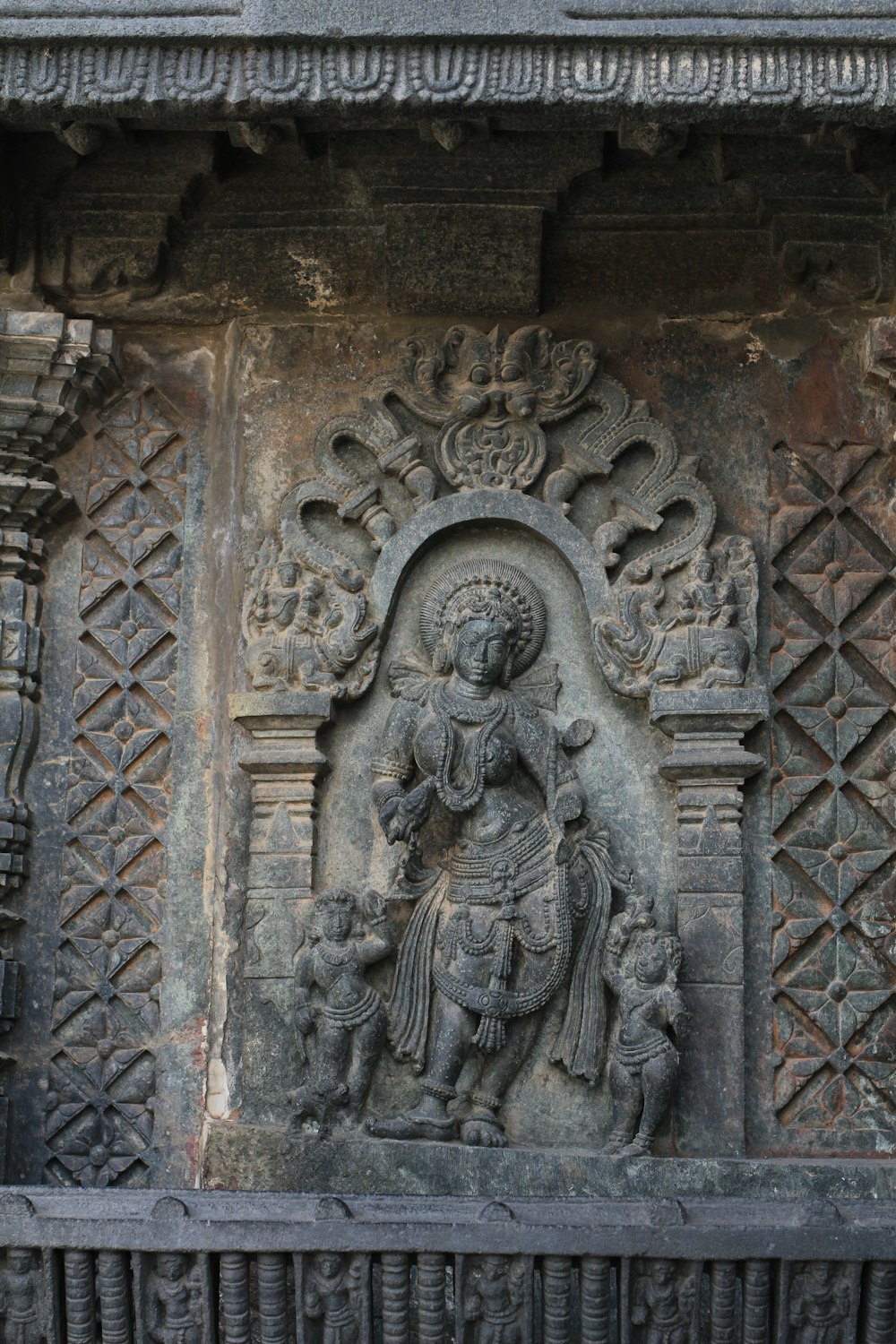 grey concrete wall with womans face embossed