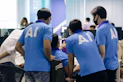man in blue nike crew neck t-shirt standing beside man in blue crew neck t