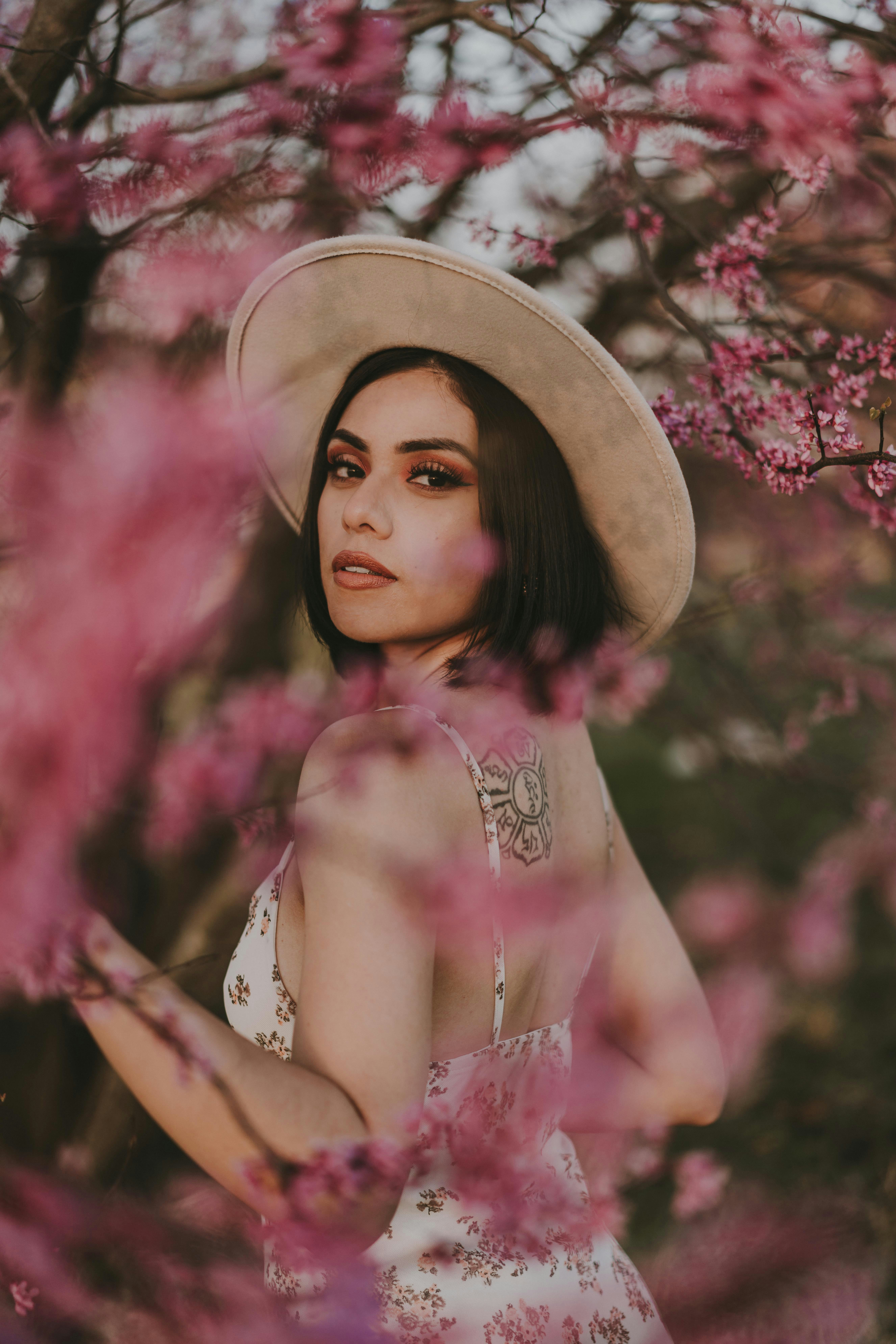 woman in pink floral dress wearing brown hat