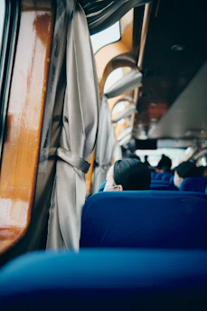 Interior view of a Vialume bus showing clean seats and happy passengers.