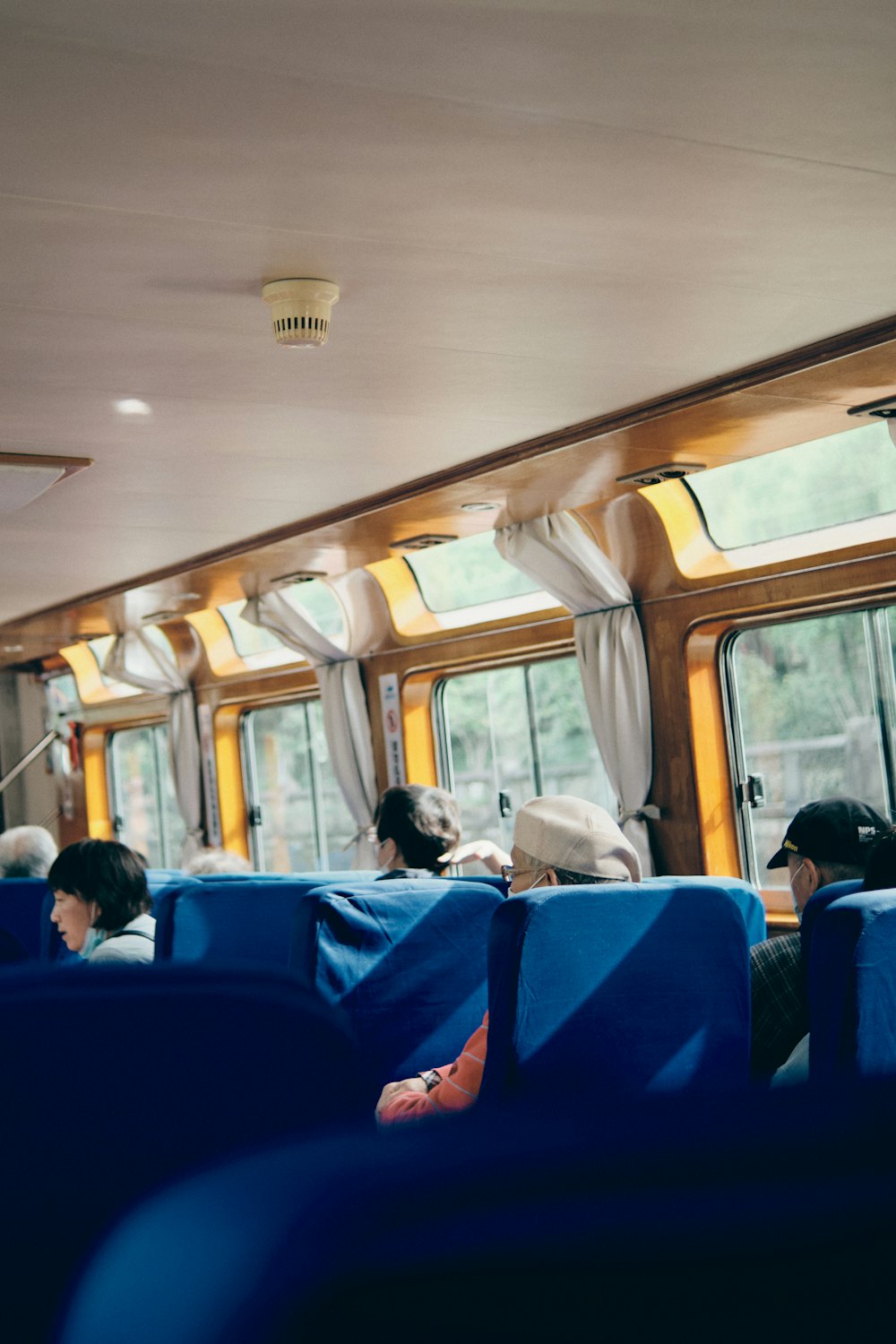 people sitting on blue bus seat