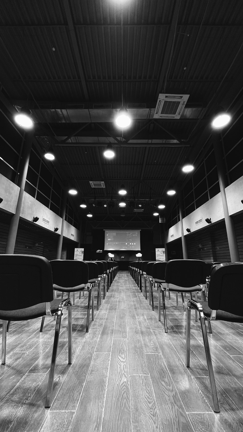 grayscale photo of chairs and tables