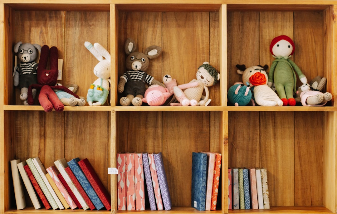  assorted animal plush toys on brown wooden shelf cupboard