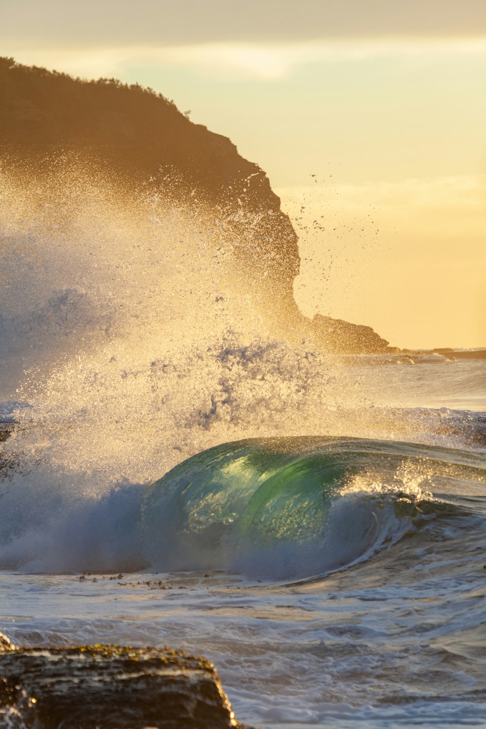 ocean waves crashing on shore during sunset