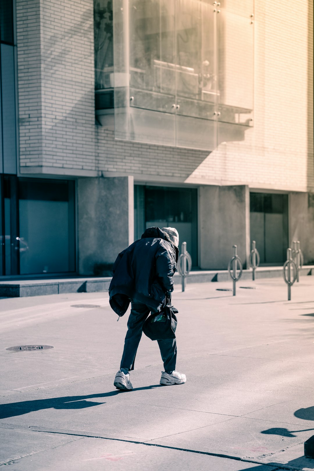 man in black jacket and pants riding skateboard