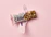 Close-up of a vibrant health bar packed with nuts, cranberries, and a drizzle of peanut butter.