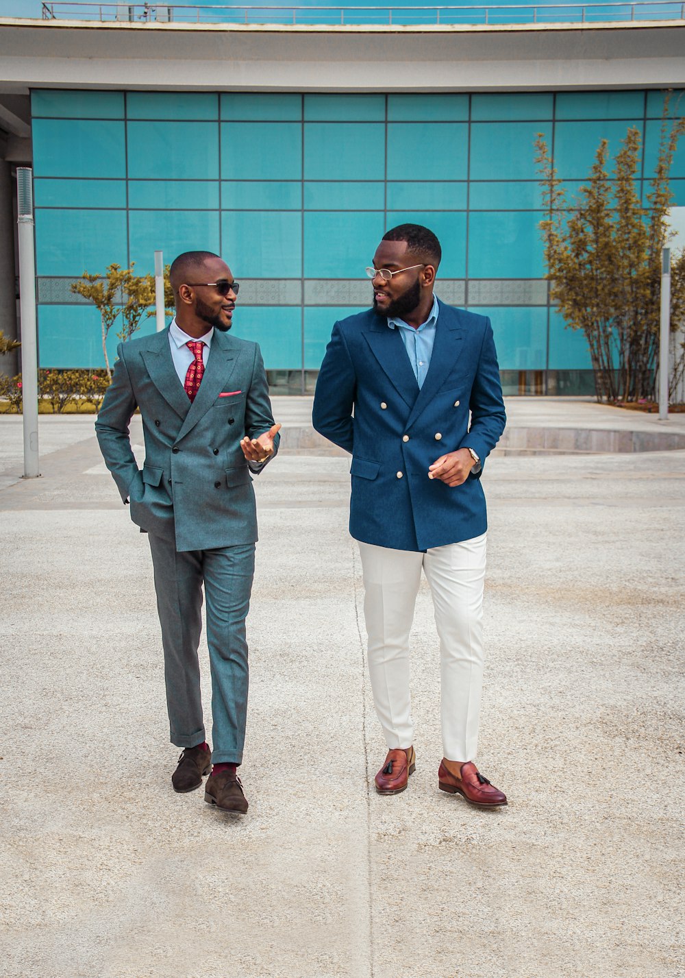 man in blue suit standing beside man in gray suit