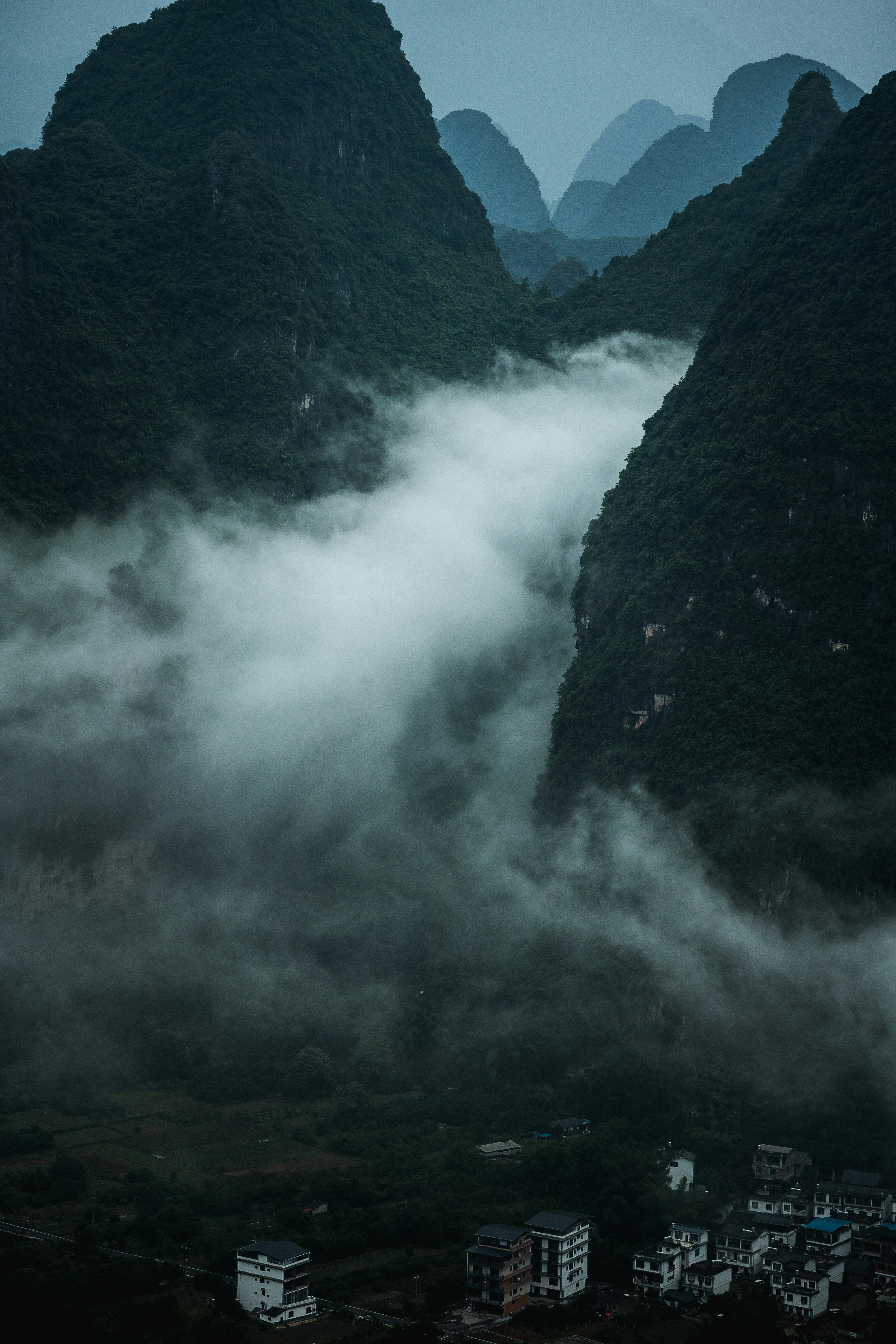 green mountains with white clouds during daytime