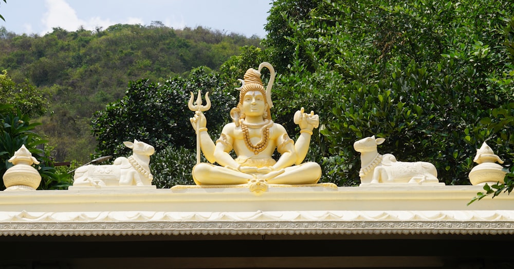 gold statue of man and woman sitting on bench