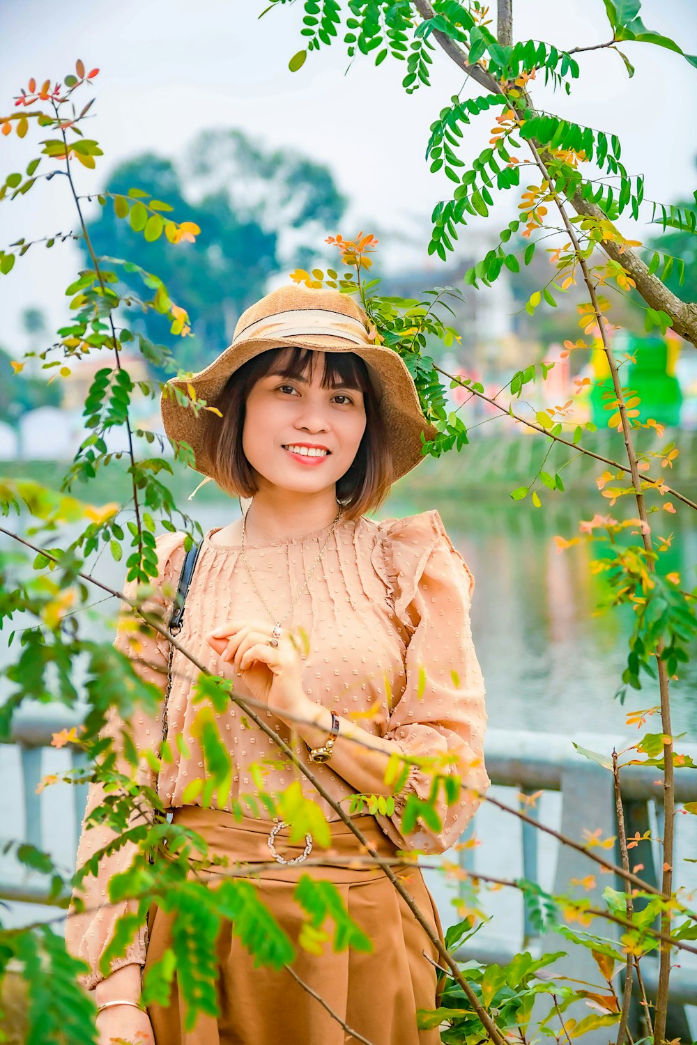 girl in brown long sleeve shirt and brown hat standing near green plants during daytime