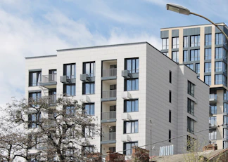 white concrete building near bare trees during daytime