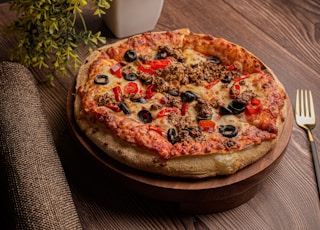 pizza on brown wooden tray