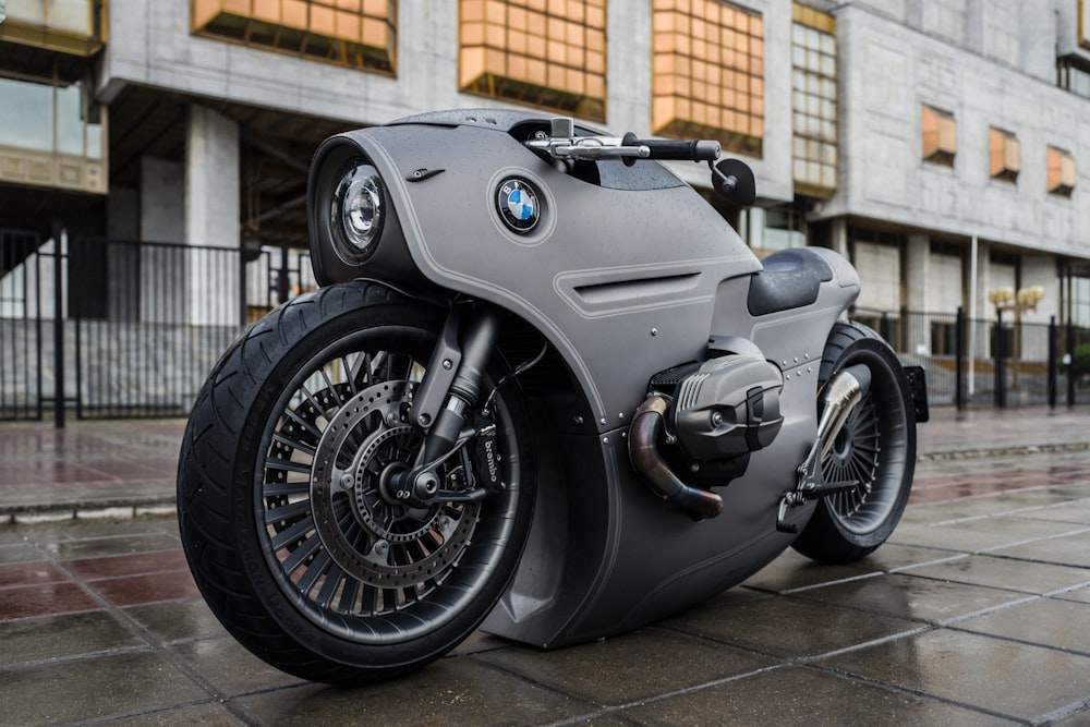 black and silver motorcycle parked on gray concrete floor