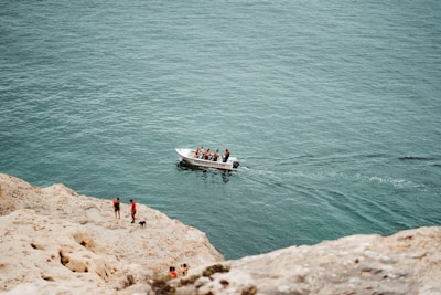 A group of tourists enjoying a boat trip along the rocky coastline of Costa Blanca.