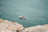 A small group laughing and relaxing on a sleek private speedboat with turquoise waters around.