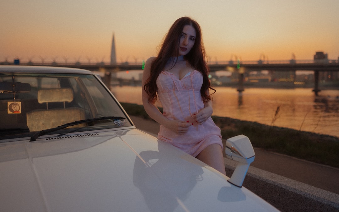 woman in white dress sitting on white car