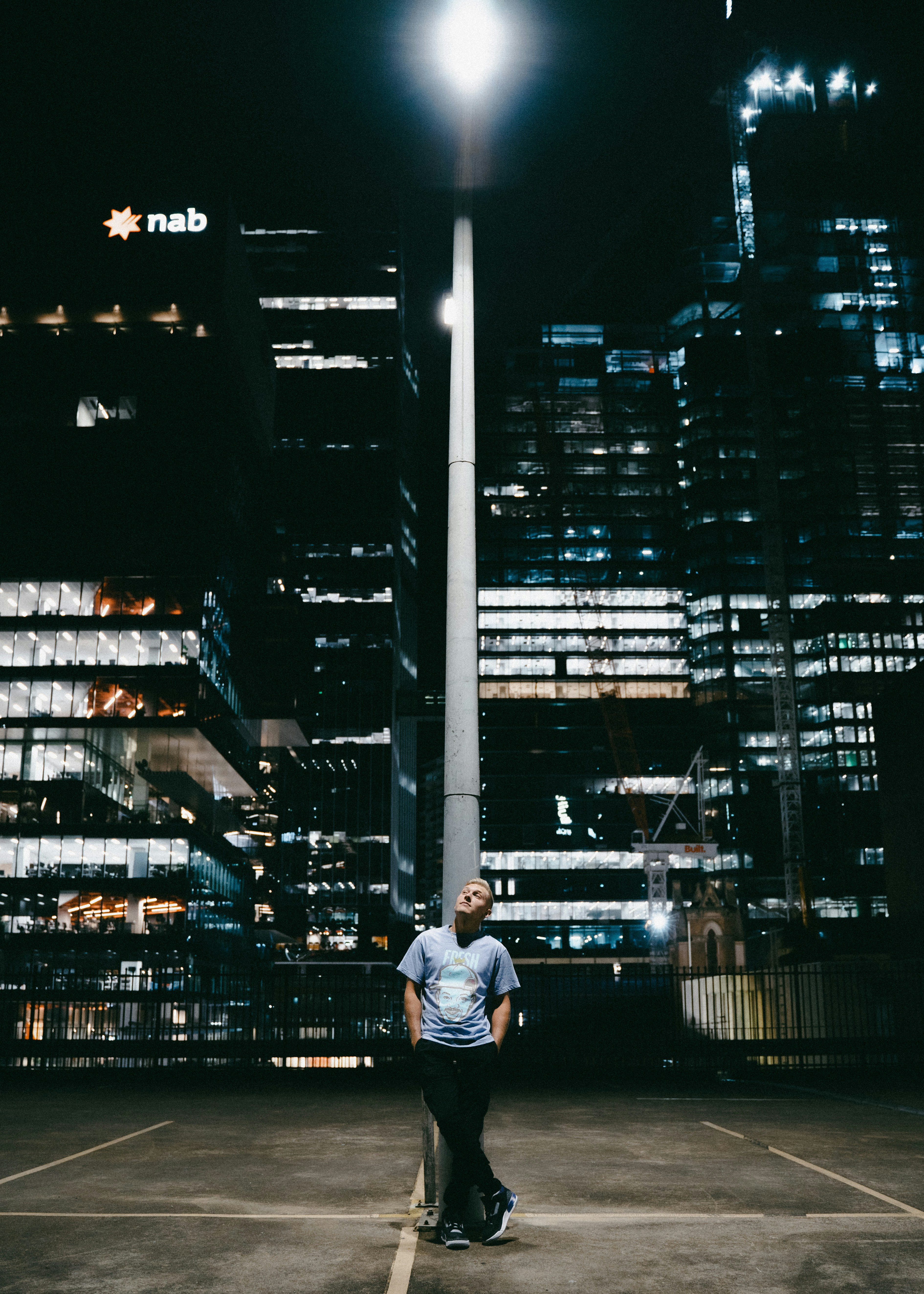 homme en chemise blanche assis sur un banc en bois marron