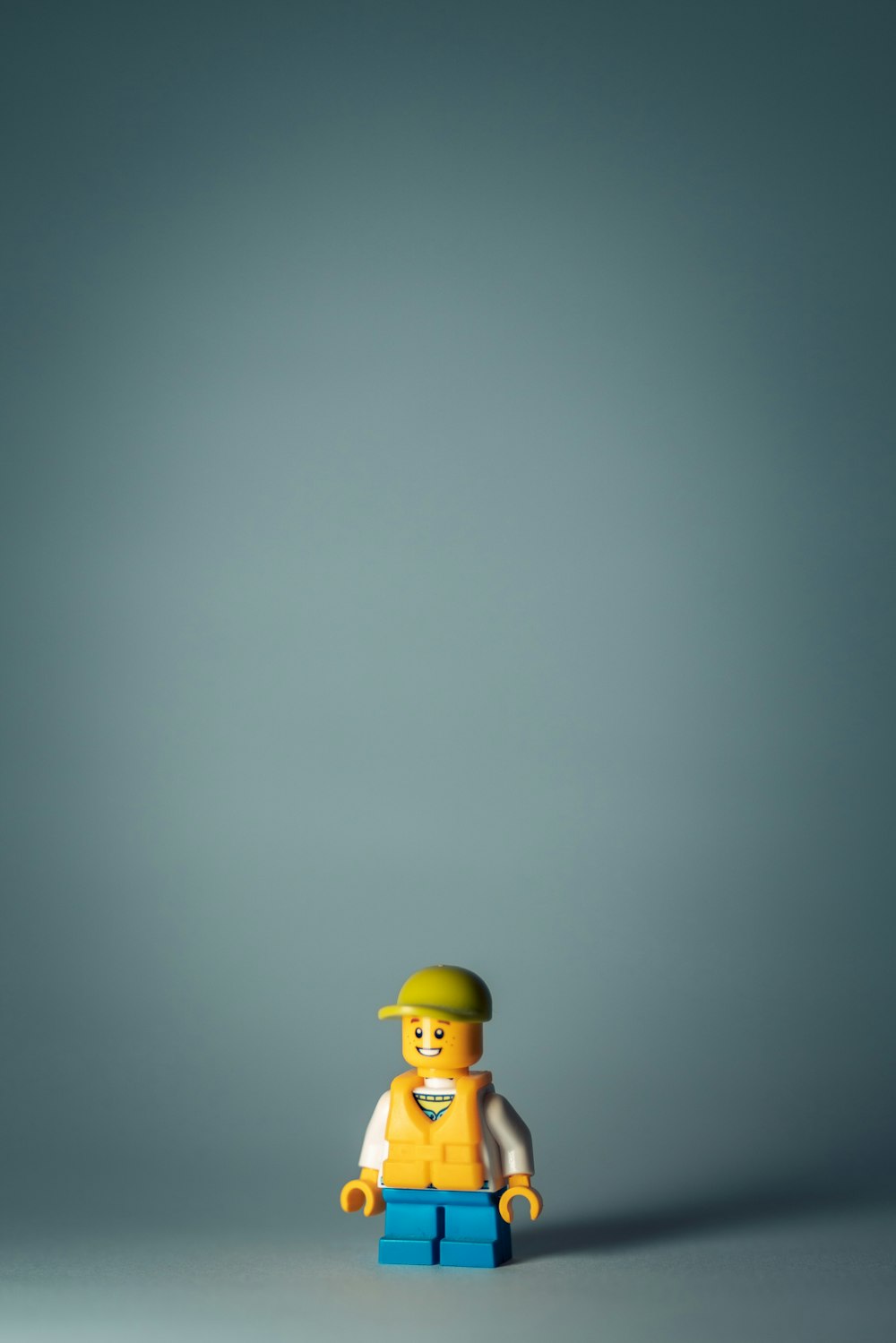 yellow lego minifig on white surface