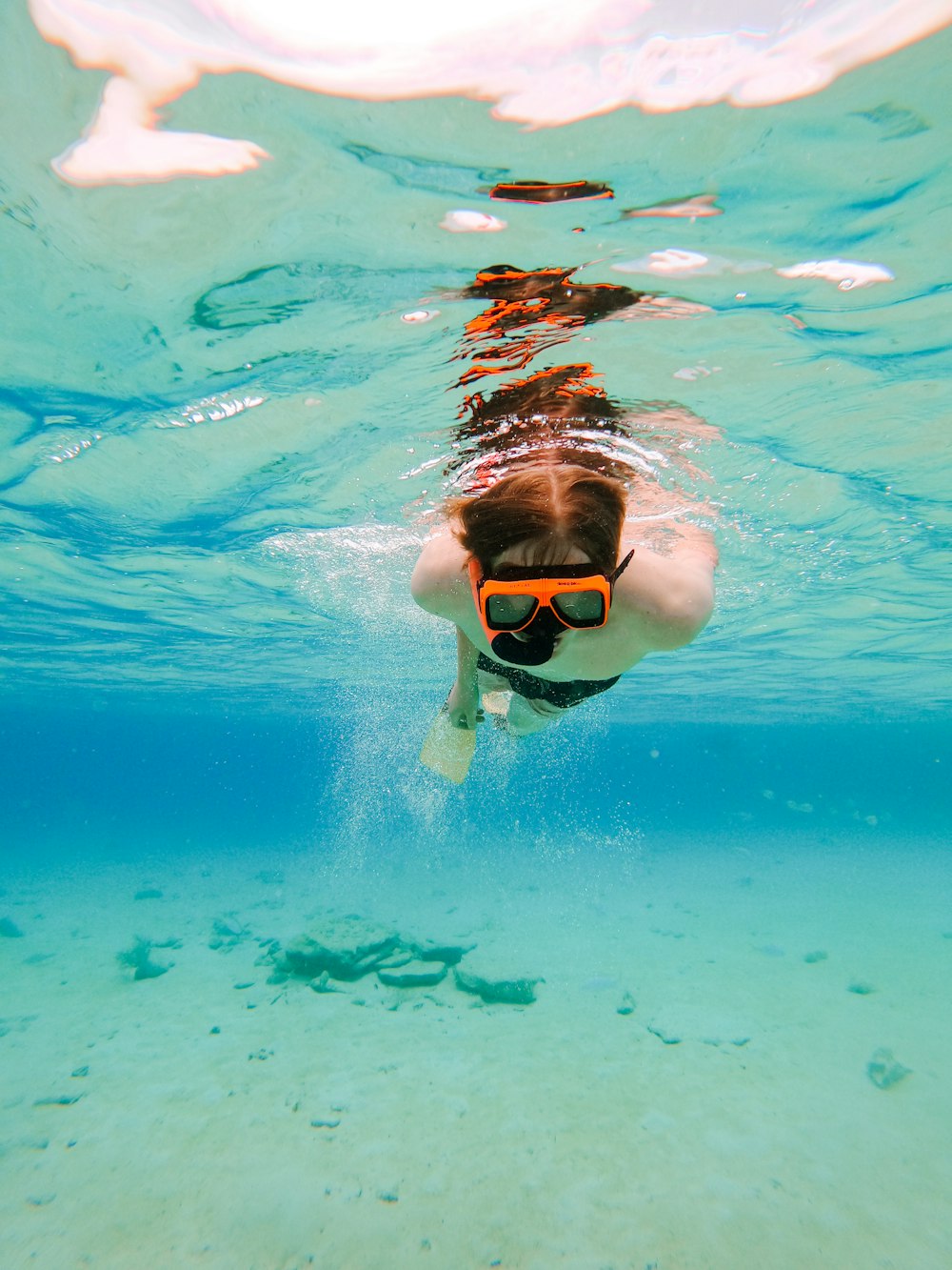 boy in swimming goggles in water