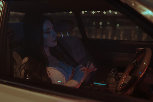 A cozy car interior with a customer relaxing comfortably during a night drive.