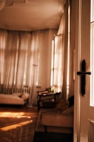 A bright, cozy single room with a bed, desk, and window showing natural light.