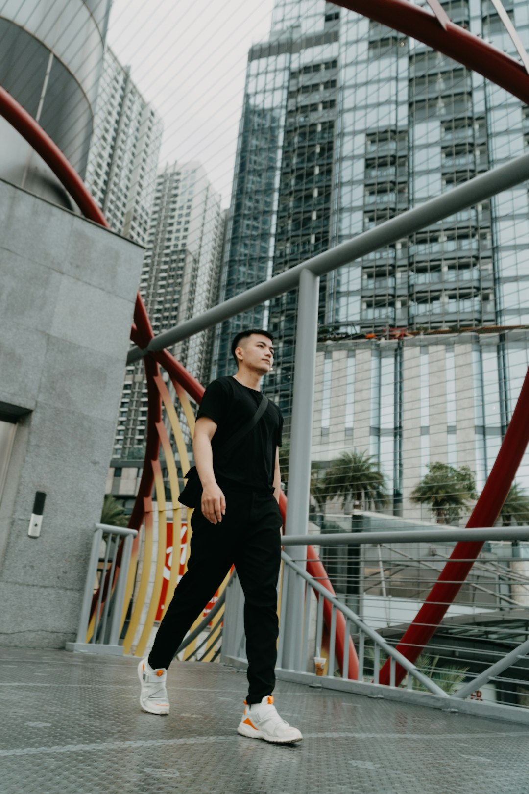 woman in black long sleeve shirt and black pants standing on red metal bar