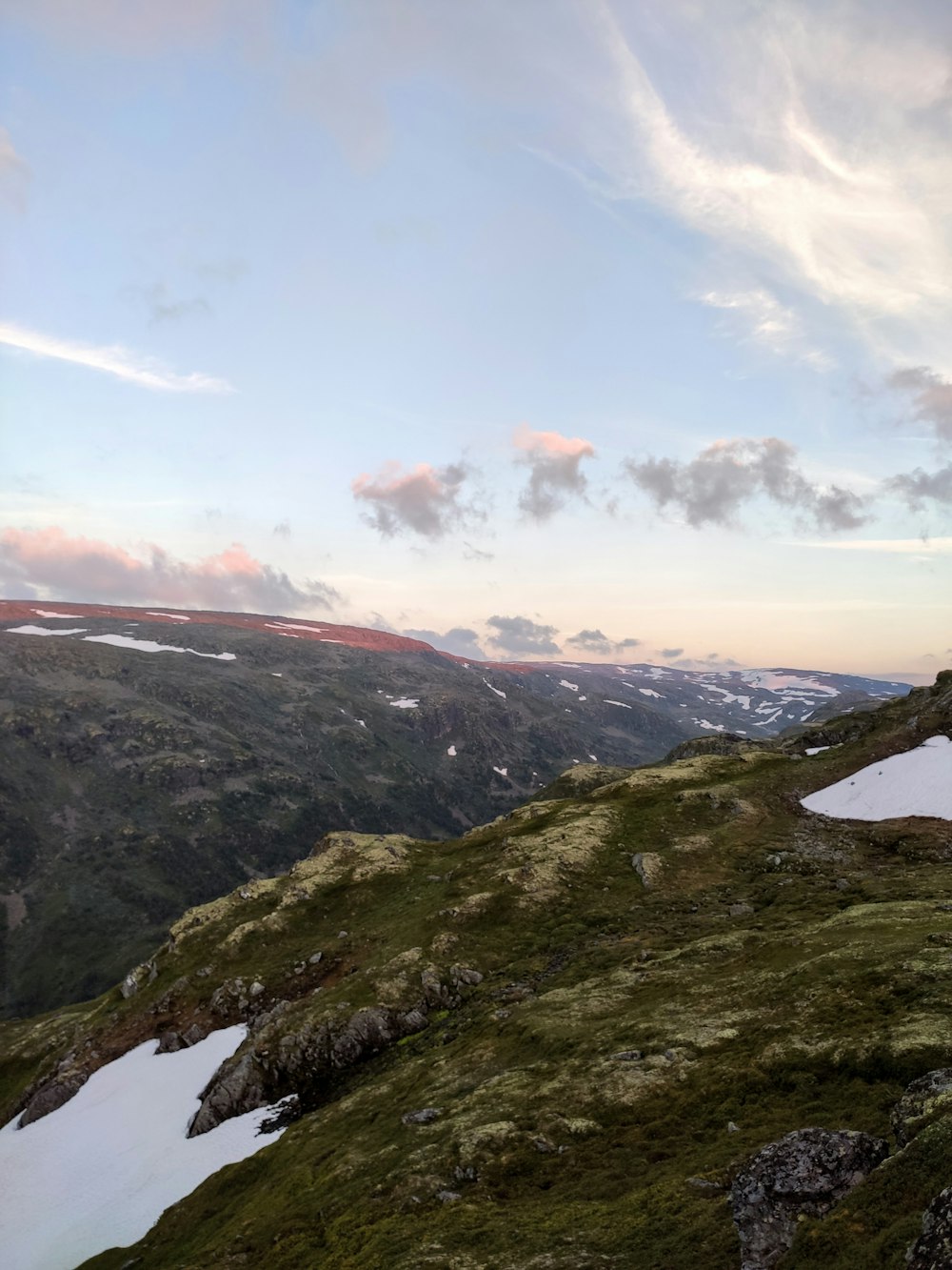 green and brown mountains under white clouds and blue sky during daytime