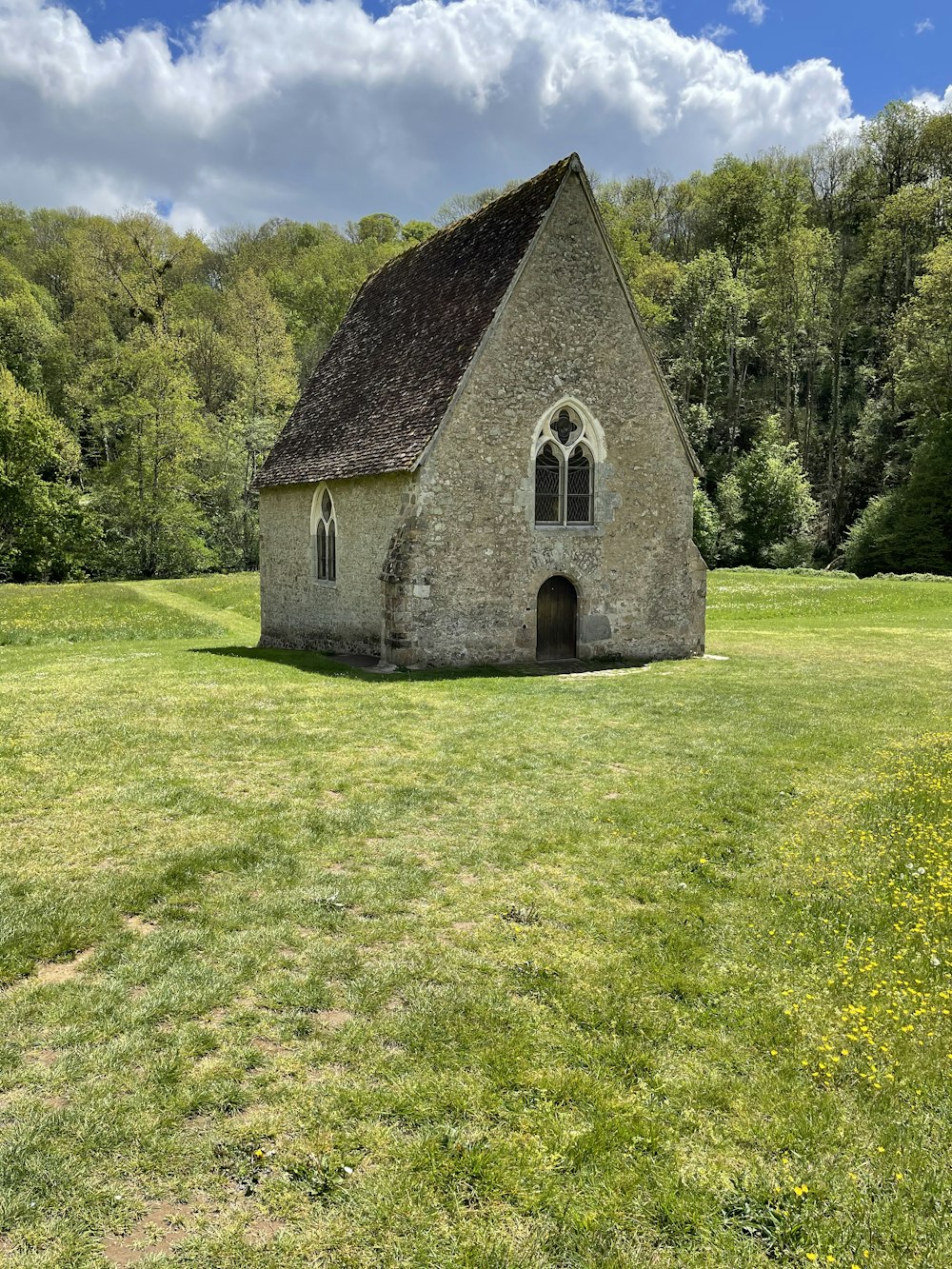 gray concrete house on green grass field during daytime