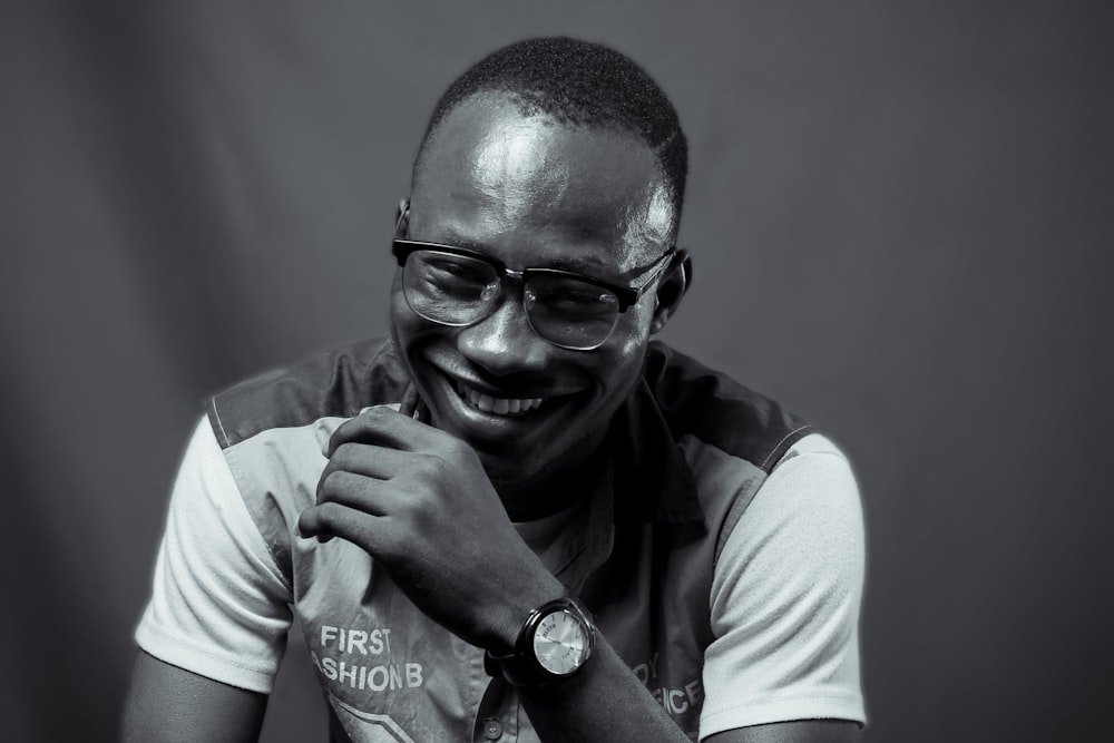 man in white and black polo shirt wearing black framed eyeglasses