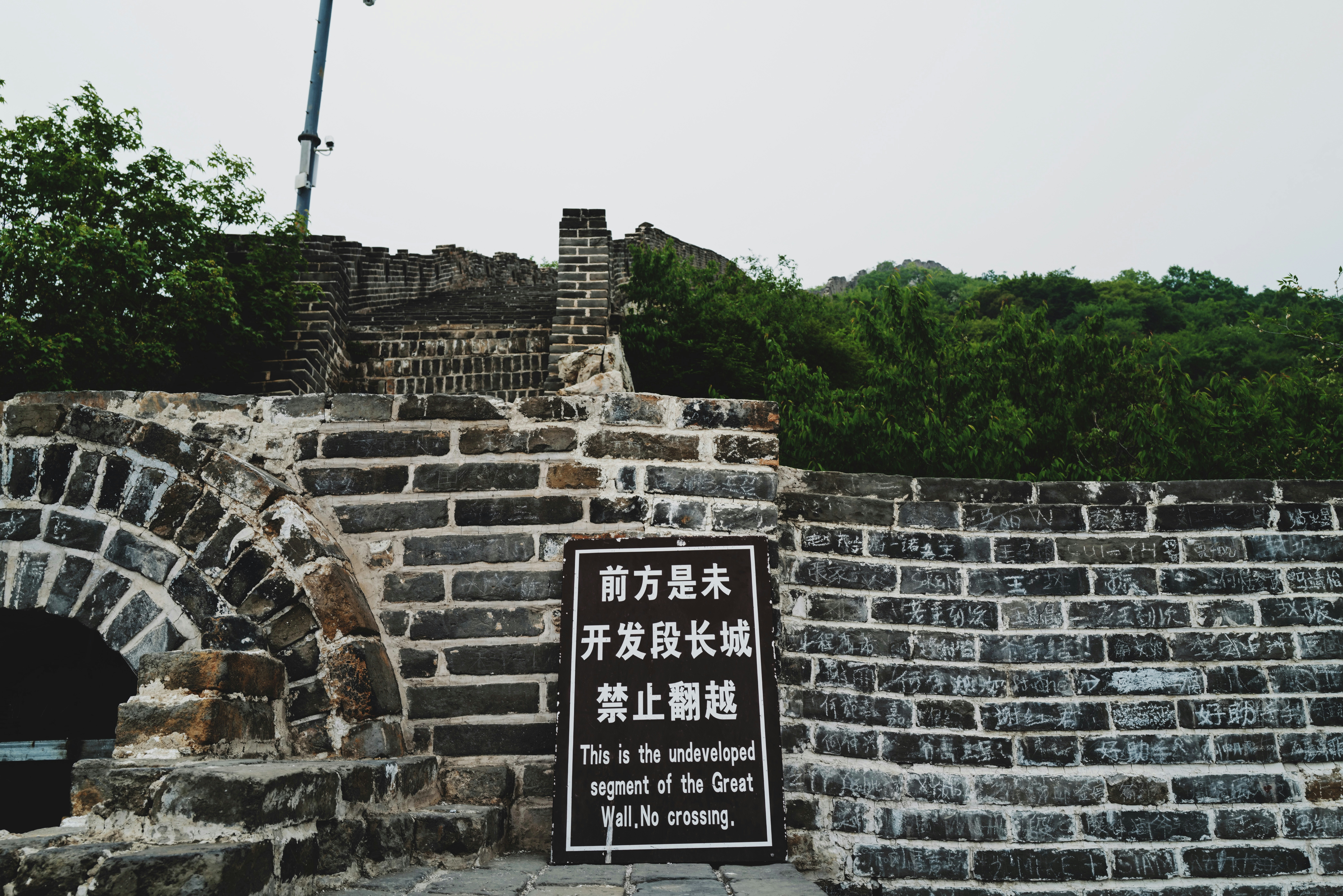black and white signage on gray brick wall