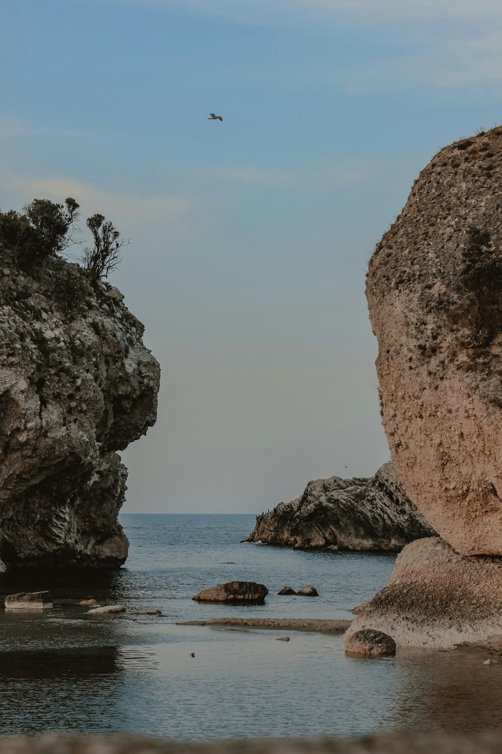 brown rock formation on sea during daytime