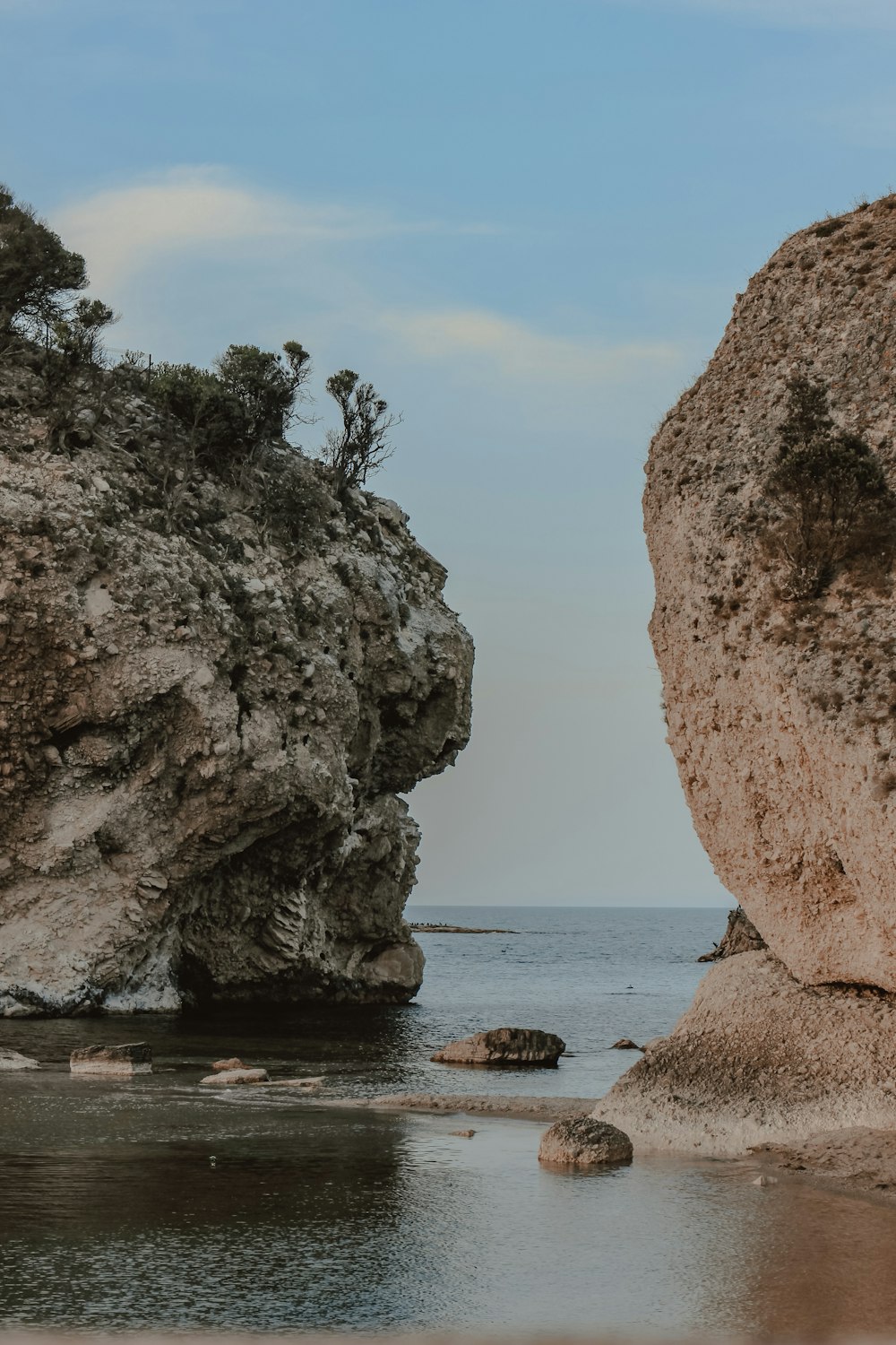 brown rock formation on sea shore during daytime