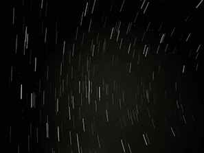 A time-lapse image showing satellite trails crossing the dark cosmos