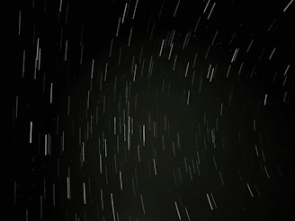 A time-lapse image showing satellite trails crossing the dark cosmos