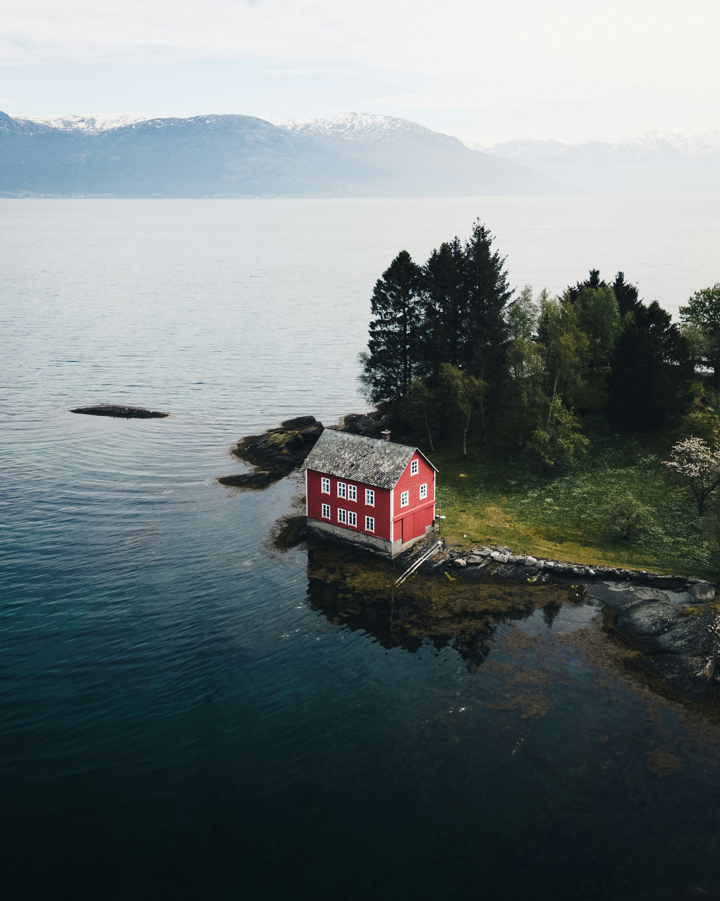 Red and white house near body of water during daytime photo – Free ...
