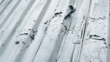 white snow on gray concrete wall