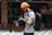 man in gray crew neck t-shirt and yellow knit cap holding black dslr camera