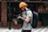 man in gray crew neck t-shirt and yellow knit cap holding black dslr camera