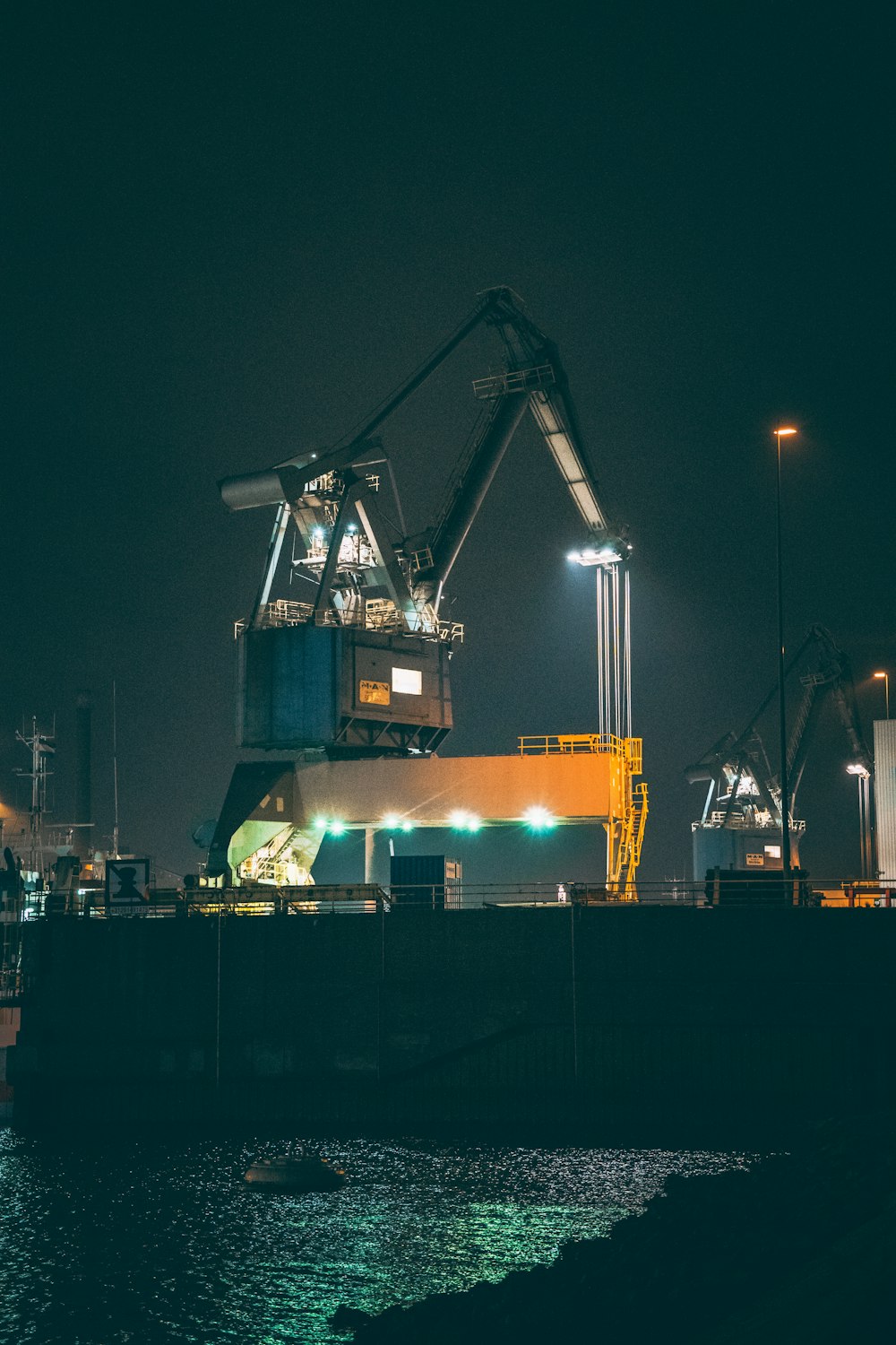 blue and orange crane during night time