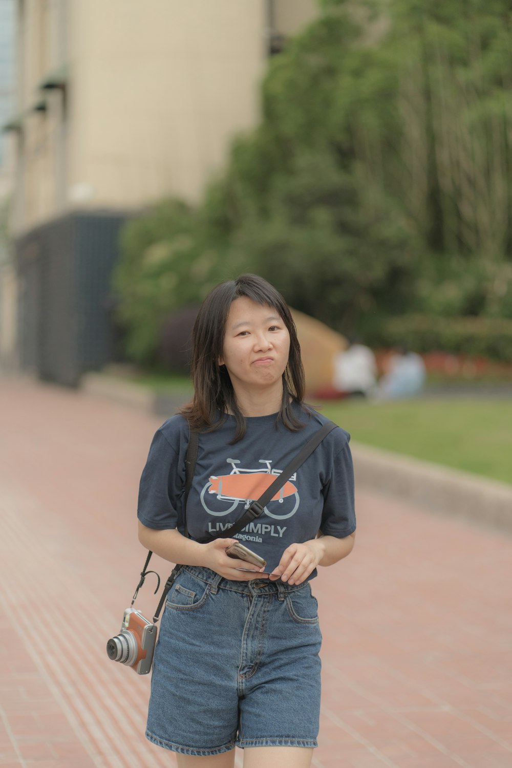 woman in blue and white adidas long sleeve shirt and blue denim shorts standing on brown