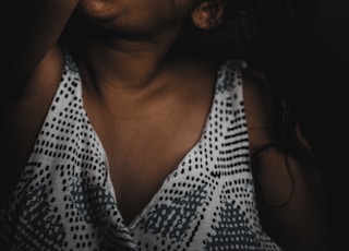 woman in black and white polka dot tank top