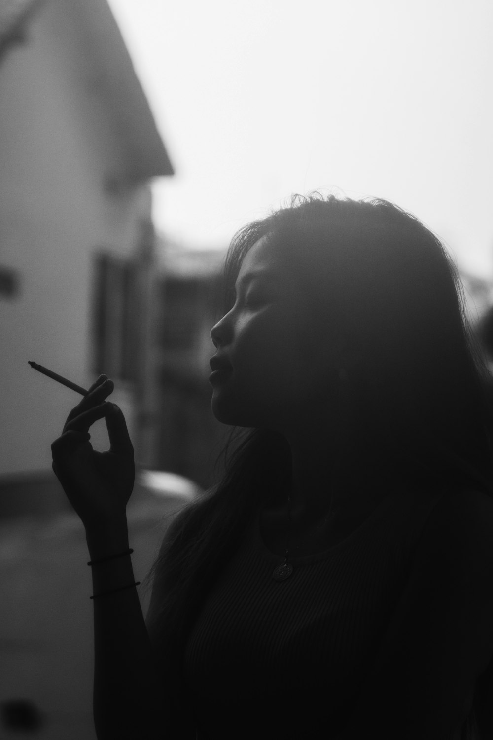 grayscale photo of woman holding smartphone