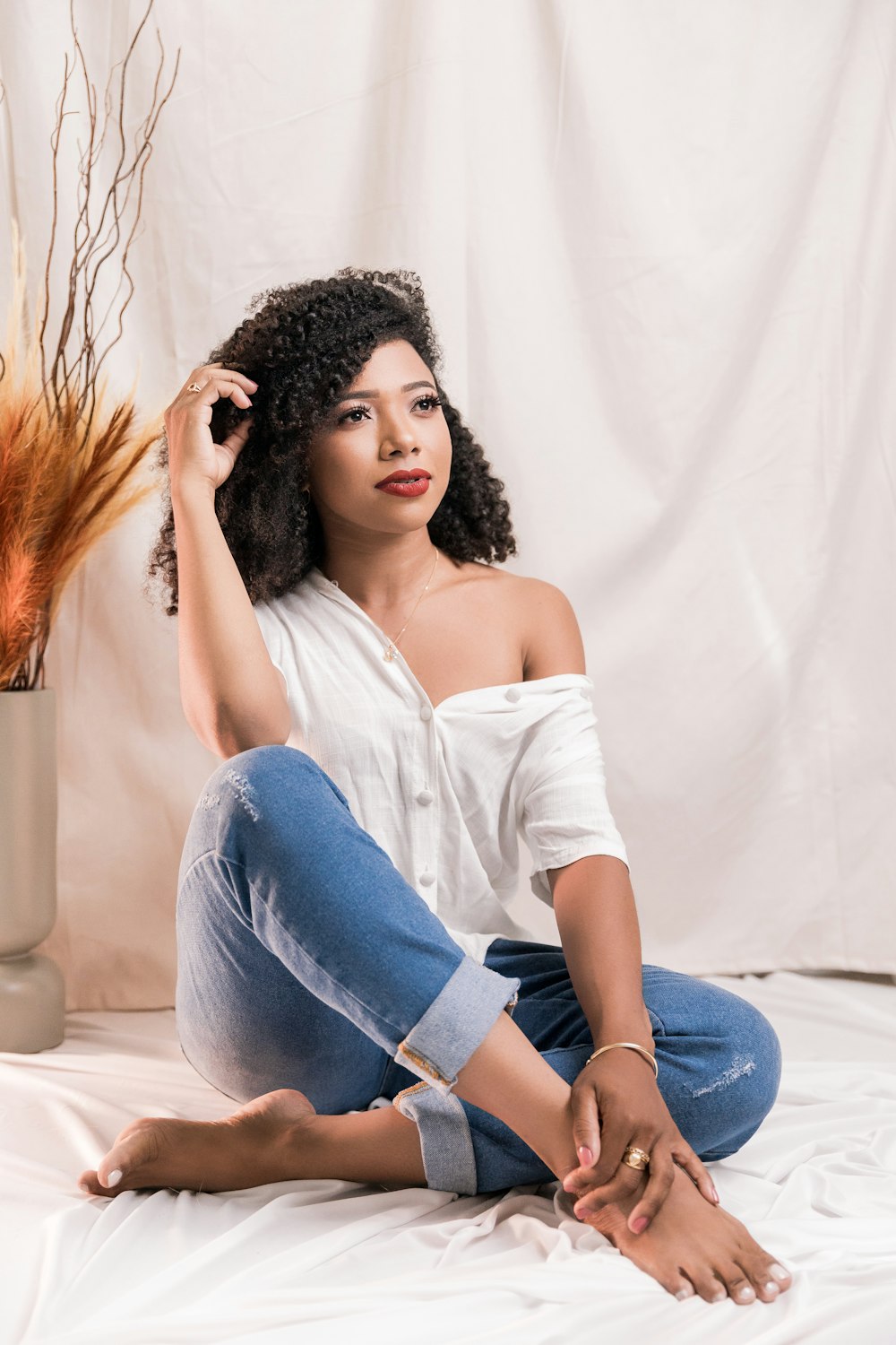 a woman sitting on a bed with her legs crossed