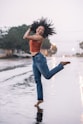 woman in blue denim jeans standing on water during daytime